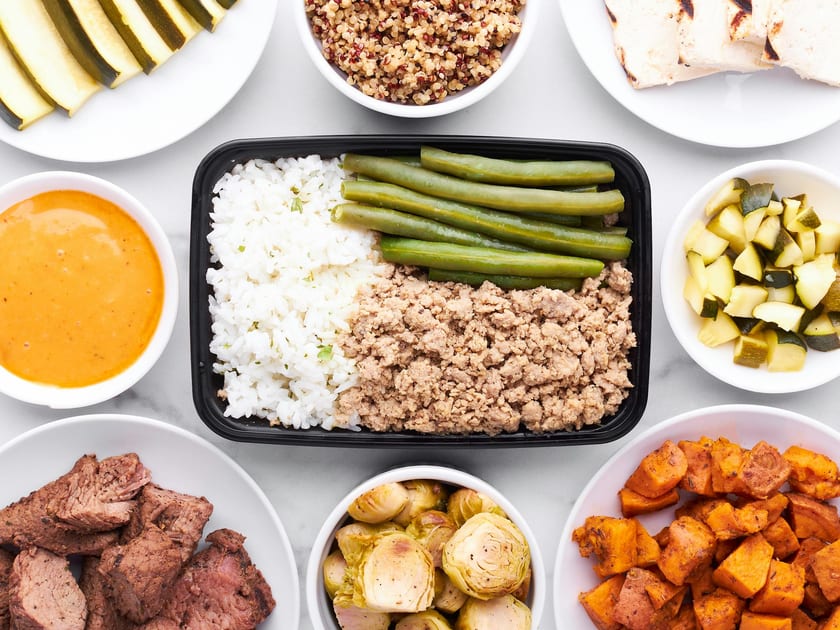 Top view of balanced meal prep with vegetables, grains, and proteins
