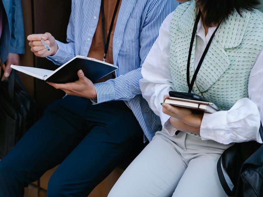 Professionals seated with notebooks during a small group discussion