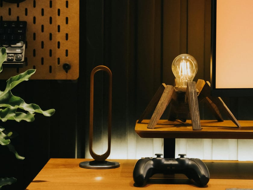 Game controller on a modern desk with a lamp and plant