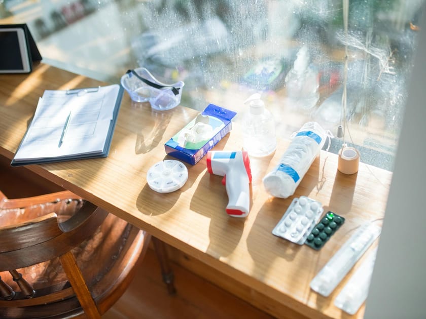 Clipboard and health-related items arranged on a sunlit desk